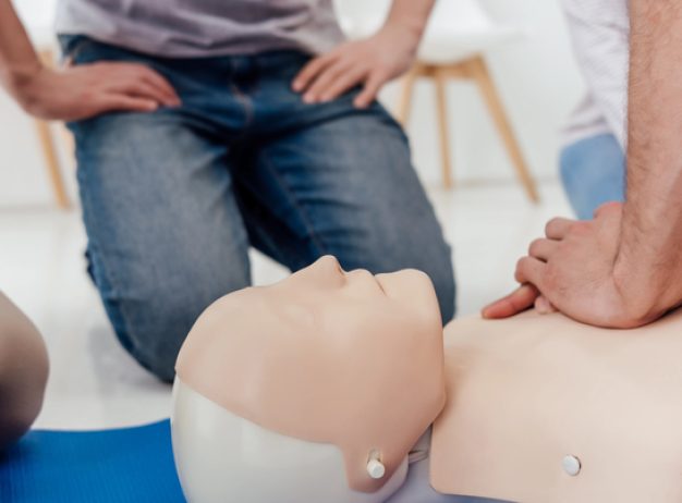 three people practicing first-aid training