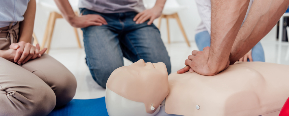 three people practicing first-aid training